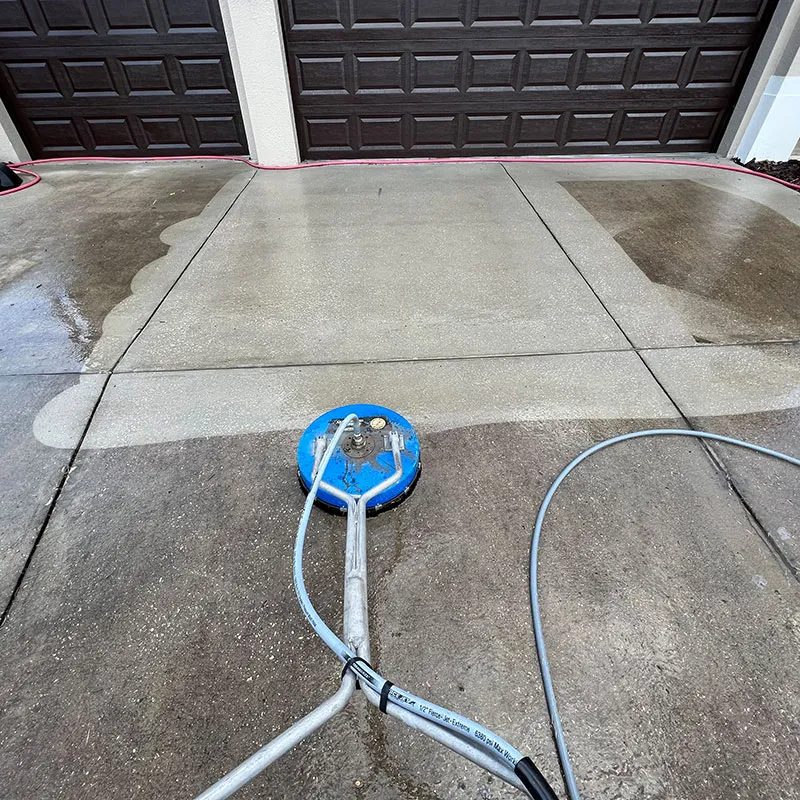 Double garage driveway pressure washing Florida — commercial surface cleaner on concrete