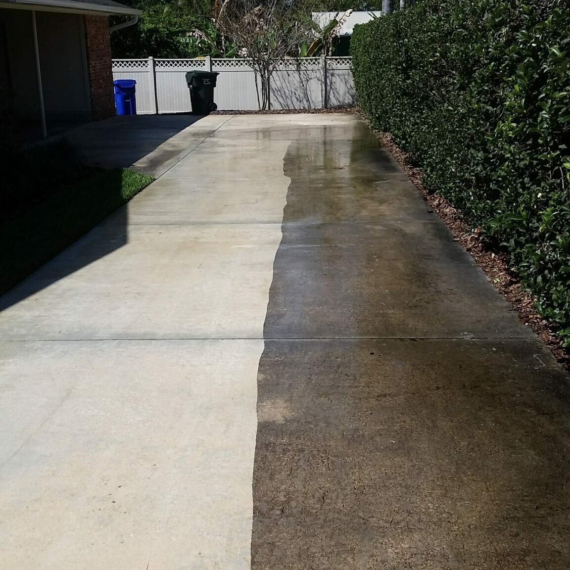 Concrete driveway pressure washing before and after — Florida home, black mold and dirt removed
